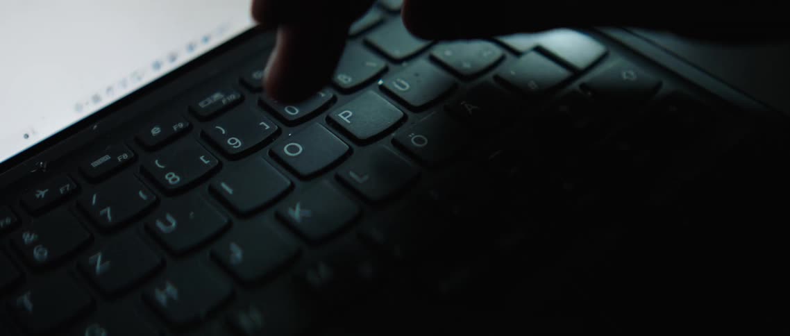 Finger pressing a few keys on laptop