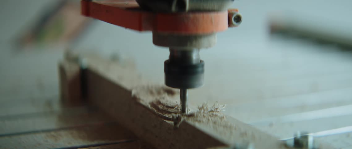 Piece of wood being drilled in a workbench