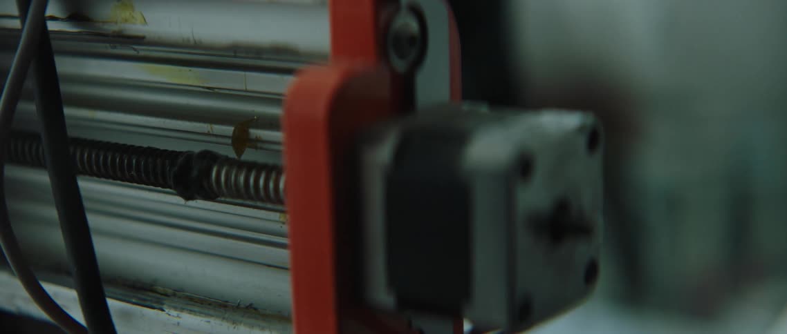 Electric motor spins a coiled rod inside a machine