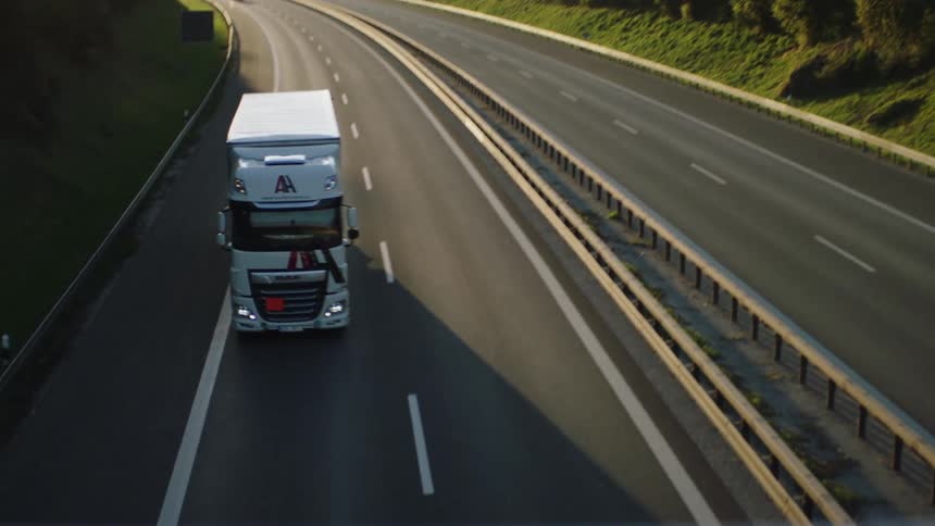 Cars and trucks driving down a highway