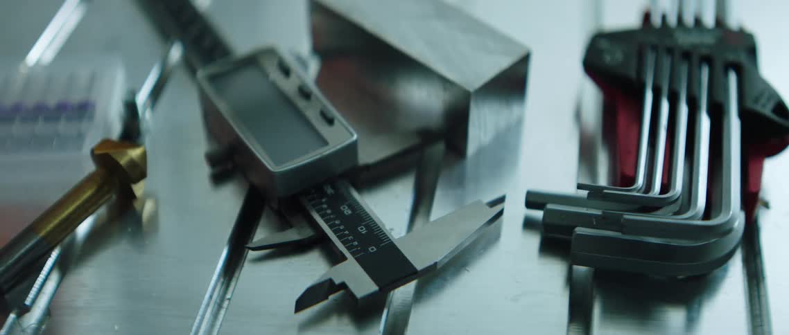 Manual tools lying atop a metal surface