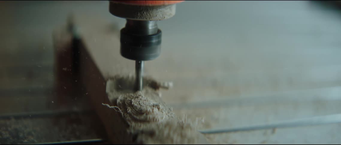 Drill drills into the wood creating sawdust