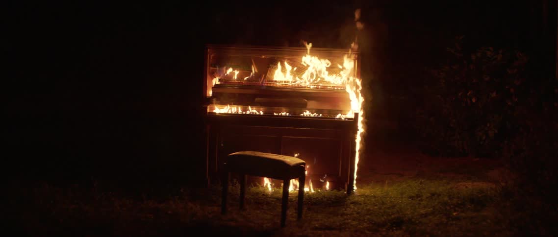 Pianola burning in the backyard at night