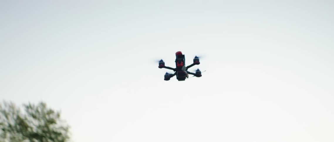 Small drone in flight at dawn