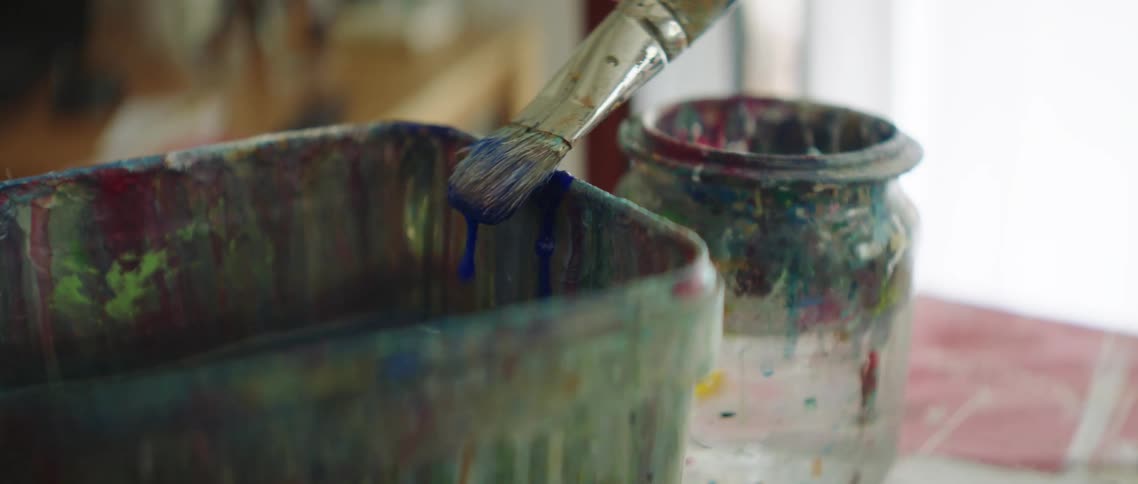 Close view of paintbrush being cleaned