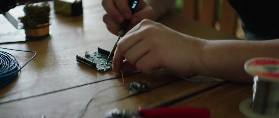 A man removes a wire from an electrical device