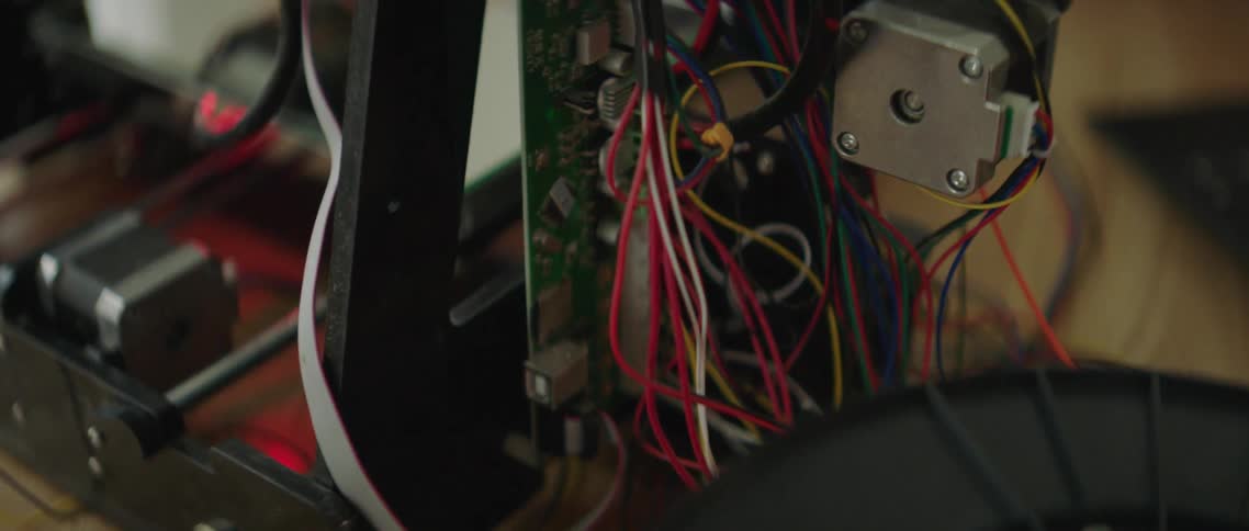A red light flashes on the side of a 3d printer