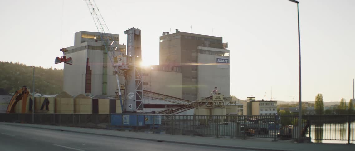 Cars driving by a factory