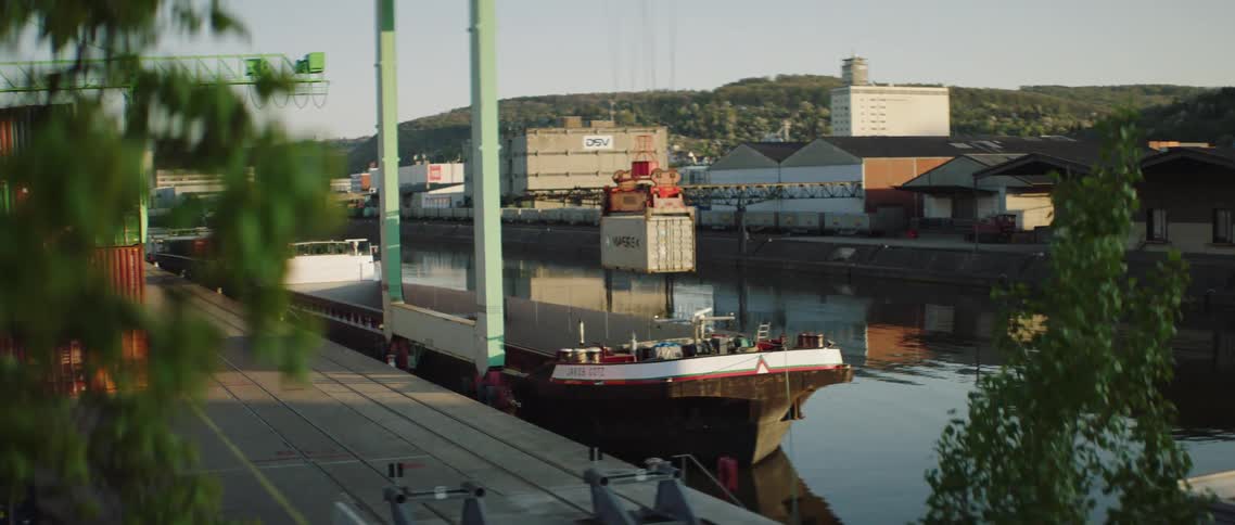 Crane lifting shipping container from cargo ship
