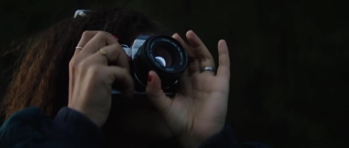 A woman takes photos outside
