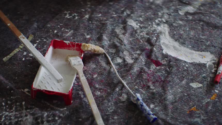Painting supplies sitting on drop cloth