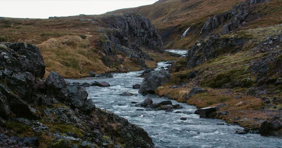 Fast moving clear stream through rocky hillside