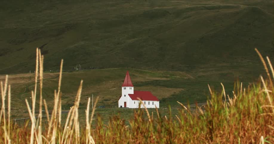 A church sits at the base of a hill