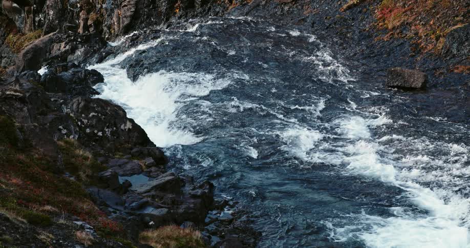 A flowing and rushing river over rock