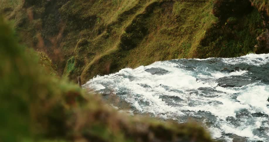 A churning river rapids give way to a waterfall