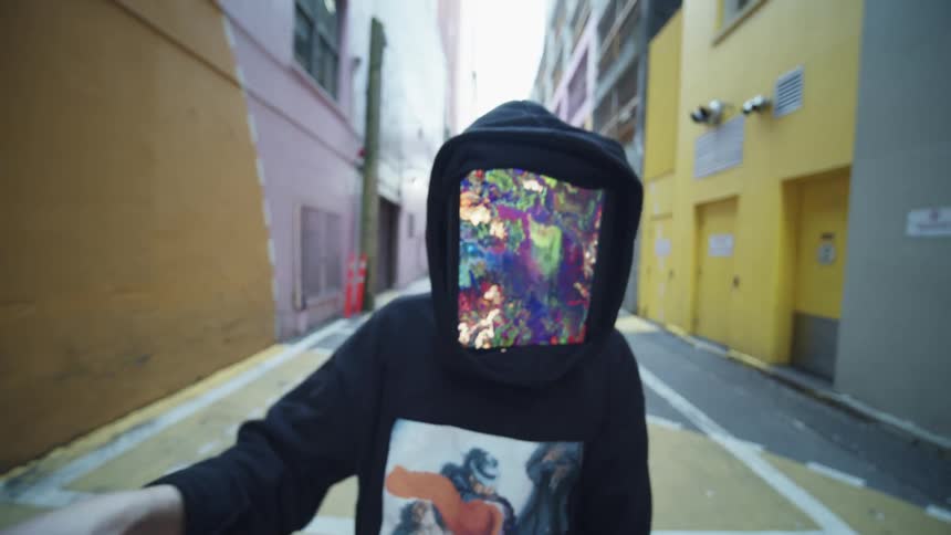 Person with a tablet for face dances on a colorful alley