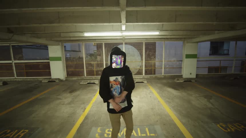 Dancer with a tablet in his head dances in a parking garage