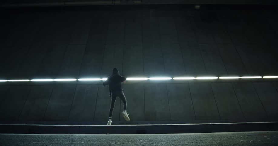 A person dances inside a large building