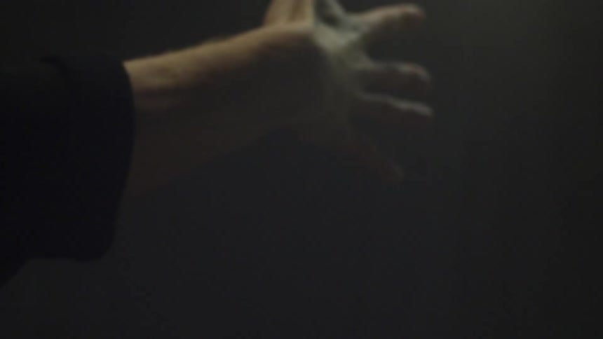 A white dancer moves his hand and forearm up and down