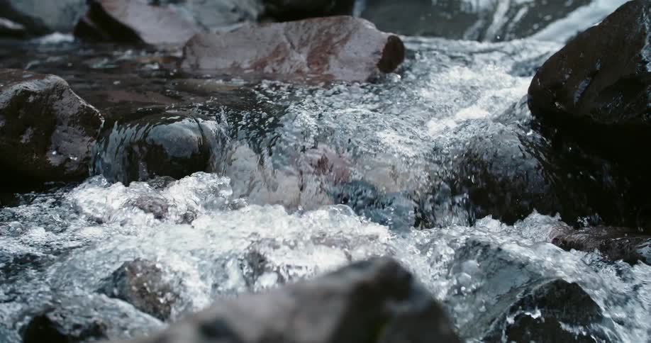 River rapids flow over dark rocks
