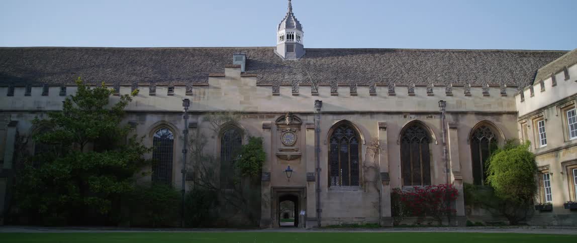 Bright green grass on the grounds surrounding a church building with arched windows