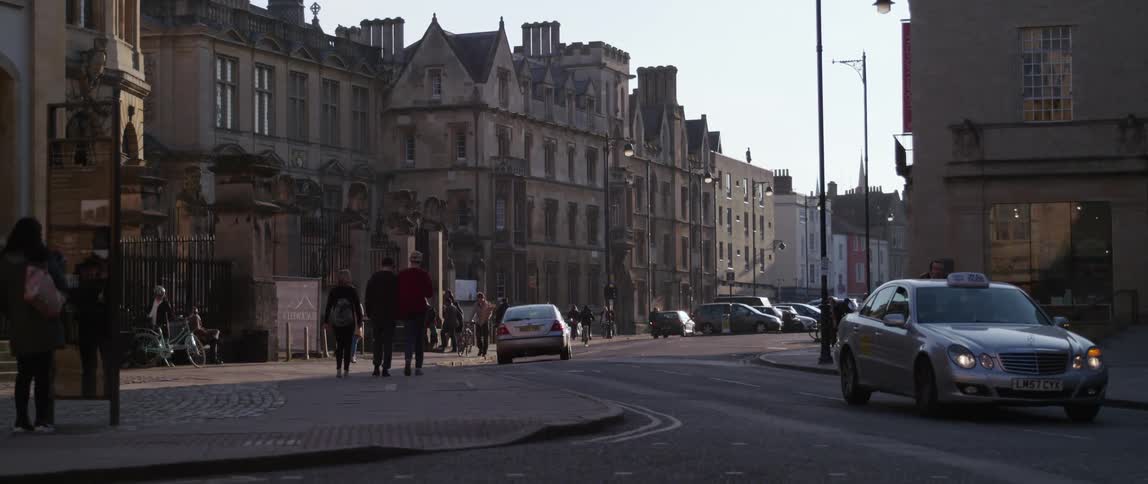 A city street in Oxford with pedestrians cyclists and cars