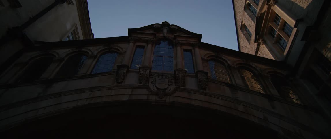 A classic historic bridge with glass windows spans between two buildings Hertford Bridge