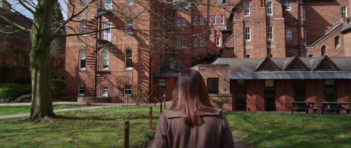 Woman walks up to the big building