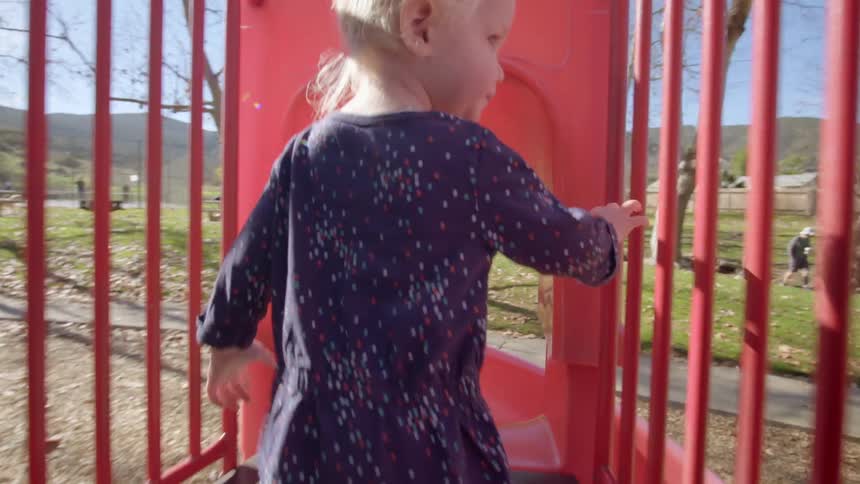 A little boy and girl play at a playground