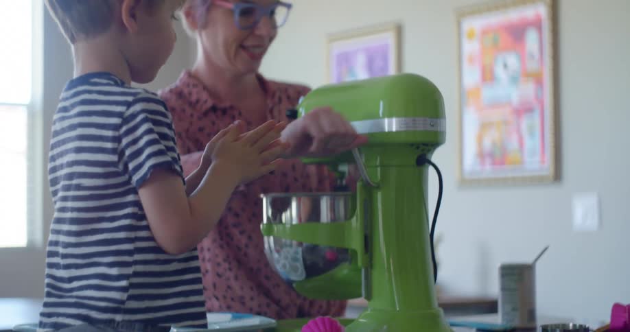 A mother and her son bake at home