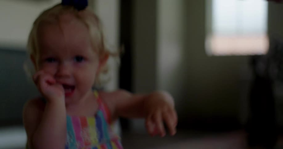 A little girl holds her parents hand and walks