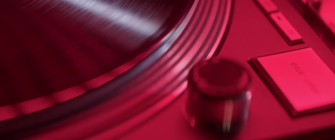 Close up of record player under red lighting
