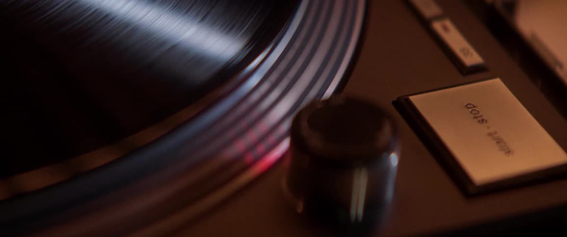 A record spins on a wooden record player