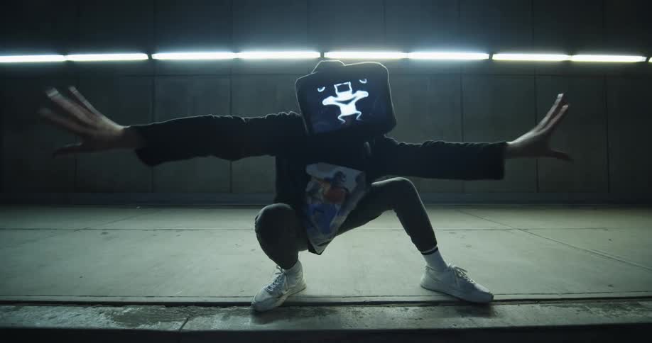 Artist performs a dance with a tablet in front of his face