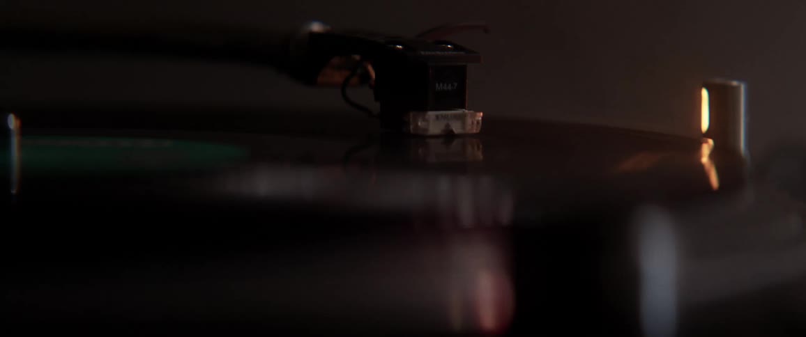 An old fashioned record player plays an album