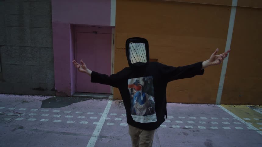 Person in animated digital mask poses with arms outstretched