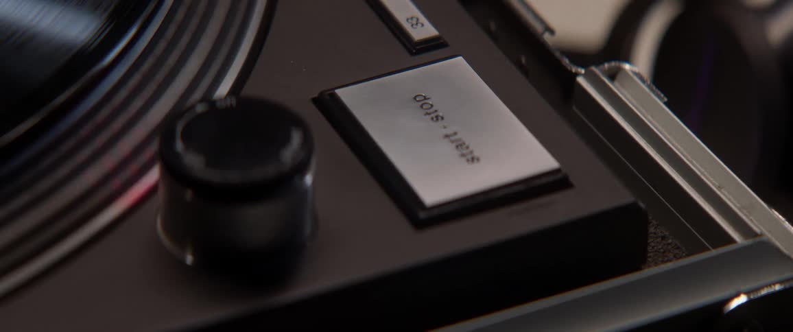 Close view of button and knob on record player