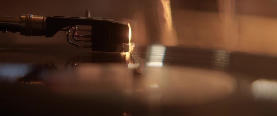 The needle slowly spins the vinyl record