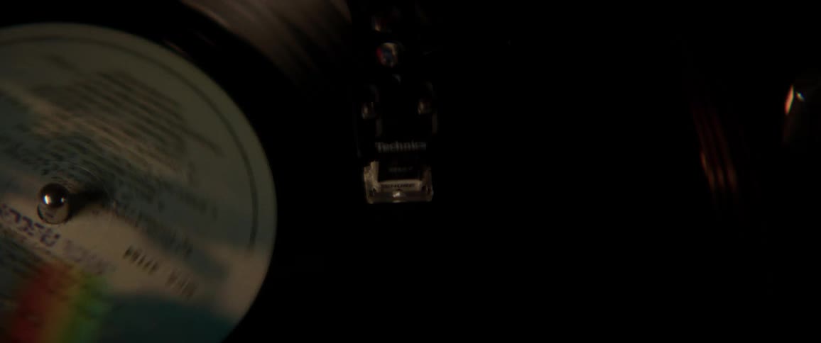 Vinyl record spinning on a turn table under strobing flashing lights