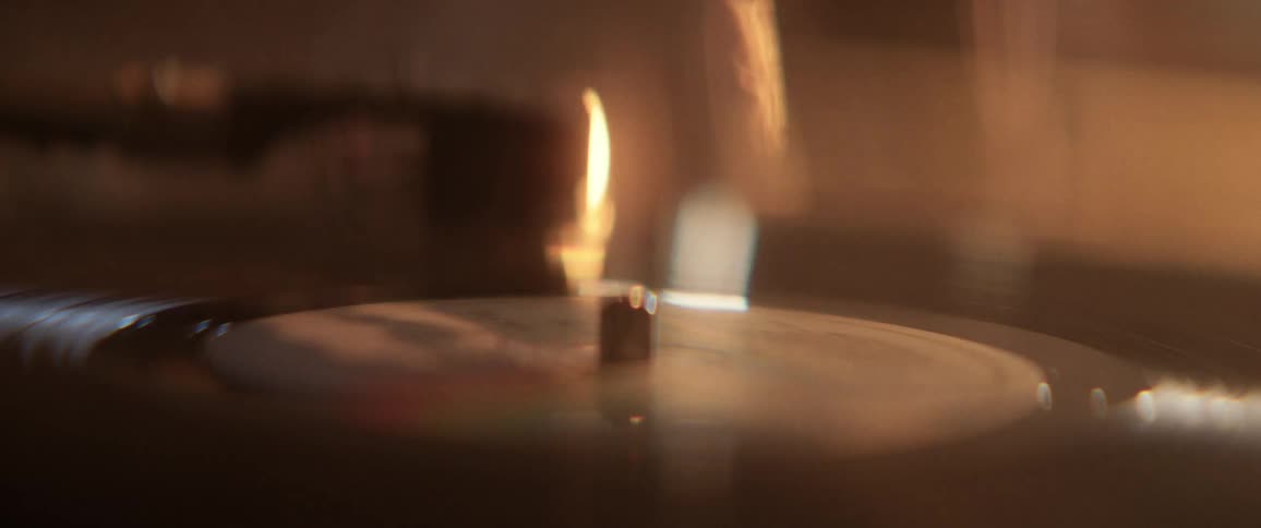 A vinyl record spinning on a record player in a dimly lit room