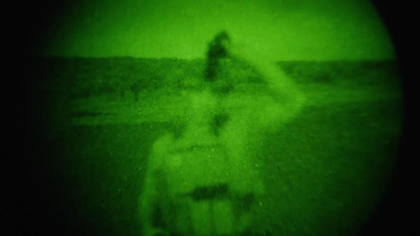The man lifts his night vision