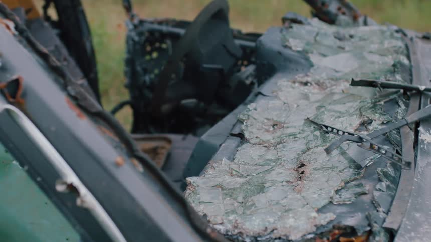 Broken windshield on a wrecked abandoned car outdoors