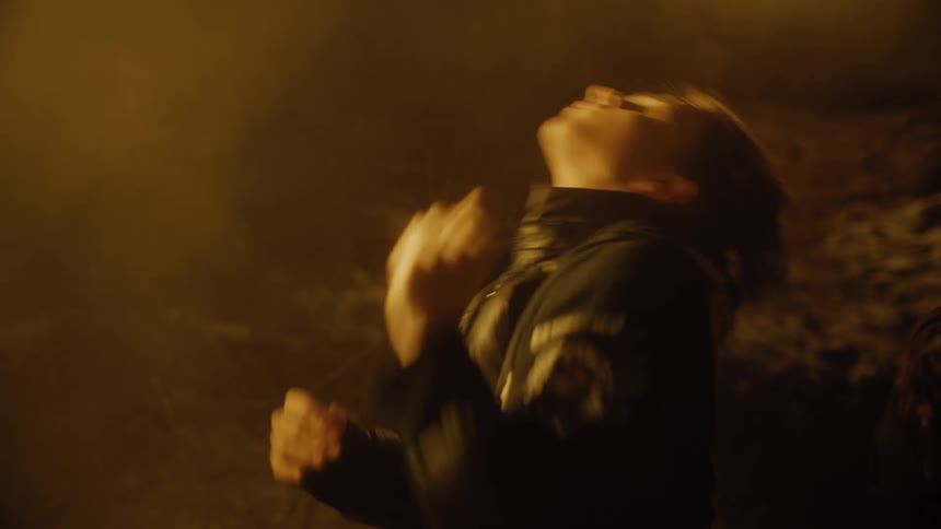 Men dancing with jackets on with smoke in the background