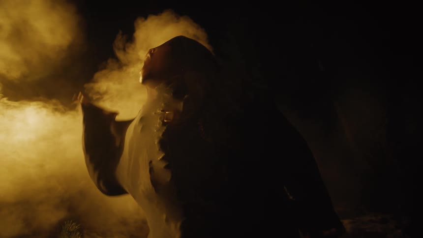 A person is waving around covered in a net in the fog