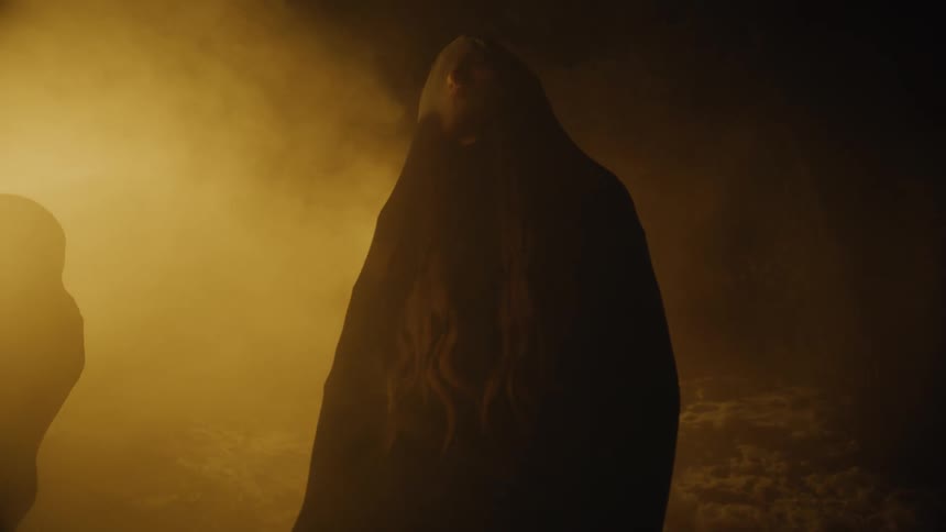 The person stands in the darkness