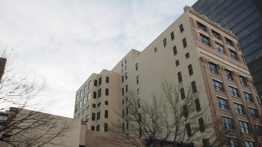A housing unit sits in the middle of a downtown urban area