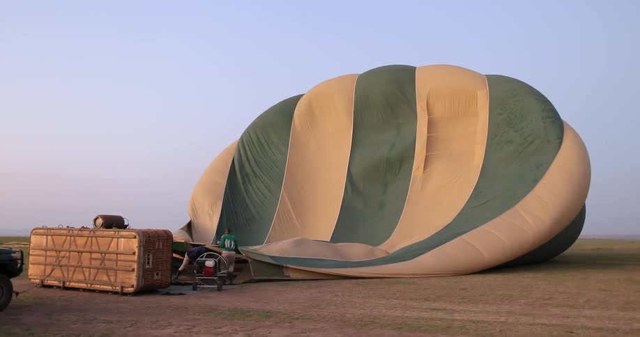 People are using a machine to fill a hot air balloon