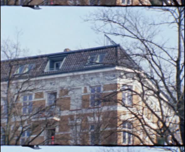 A large building behind a fence