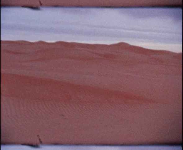 Sand dunes form peaks in the desert
