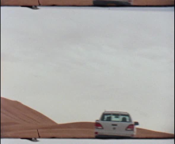 Pickup truck drives in the desert